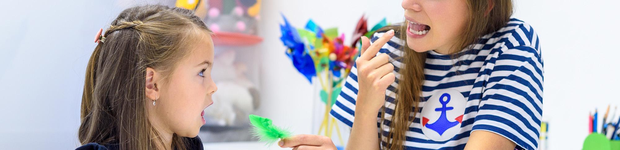 Speech pathologist working with young girl